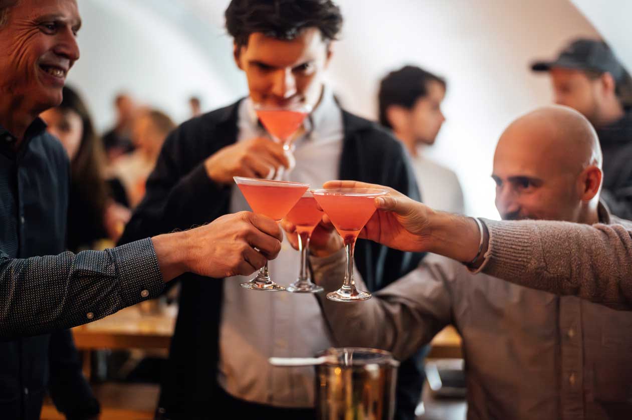 Guests cheering with freshly made cocktails